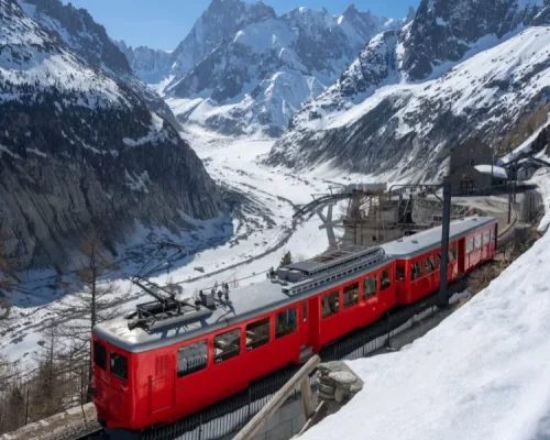 Montenvers Train (Cogwheel Train) with Les Grandes Jorasses Peaks and Mer De Glace Glacier. View of Vallee Blanche (Winter Ski Resort) of the Mont Blanc Massif, Alps, Haute-Savoie, France